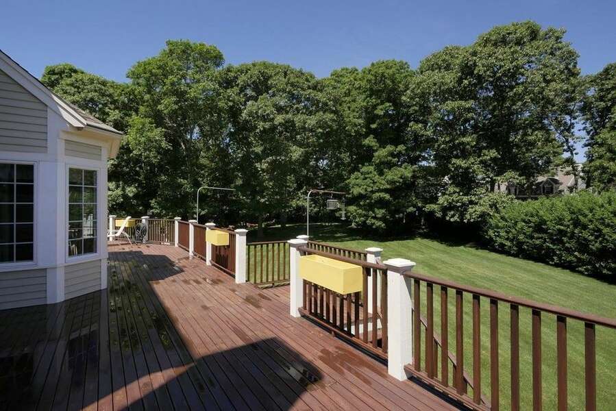 Large deck with outdoor furniture including a table & chairs. Gas grill as well - 2 Mashpa Road Harwich Cape Cod - New England Vacation Rentals- #BookNEVRDirectHarwichFamilyTides