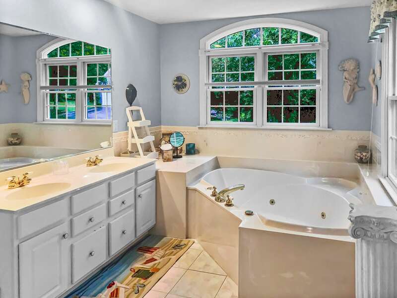 The en suite bathroom to the master bedroom has a jetted tub, separate shower, and double vanity - 2 Mashpa Road Harwich Cape Cod - New England Vacation Rentals- #BookNEVRDirectHarwichFamilyTides