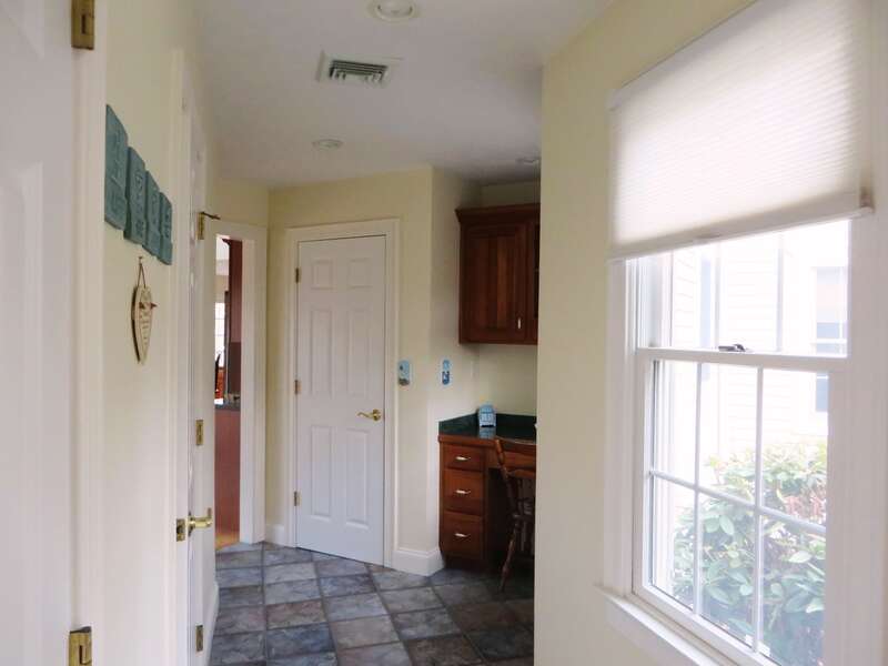 The hallway on the 1st floor leads to a half bath and second stairway - 2 Mashpa Road Harwich Cape Cod - New England Vacation Rentals- #BookNEVRDirectHarwichFamilyTides