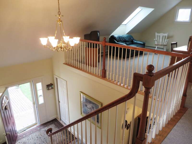 Top of the stairway looking over the entry and loft area - 2 Mashpa Road Harwich Cape Cod - New England Vacation Rentals- #BookNEVRDirectHarwichFamilyTides