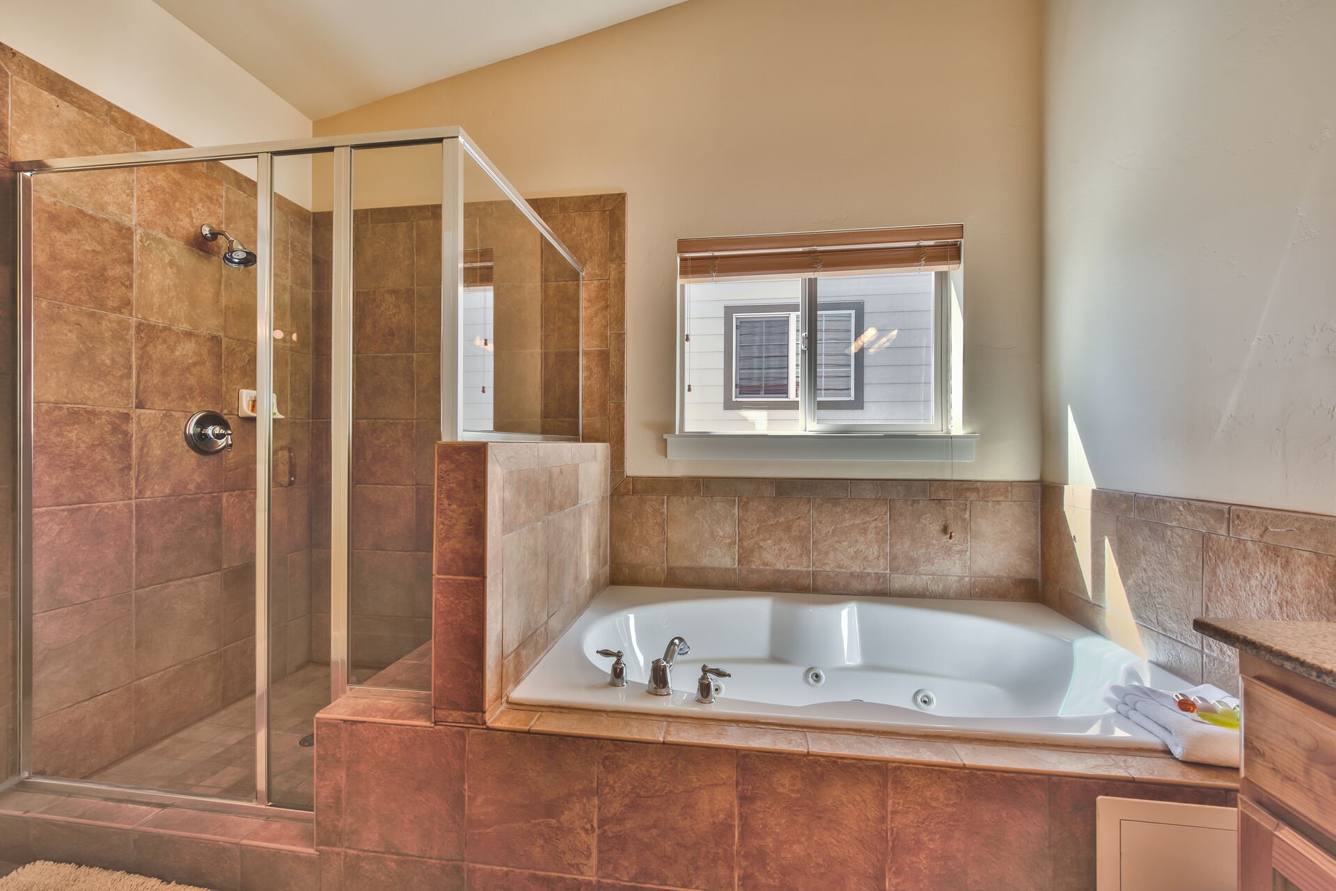 Private Bath with Jetted Tub, Tile Shower and Dual Sinks