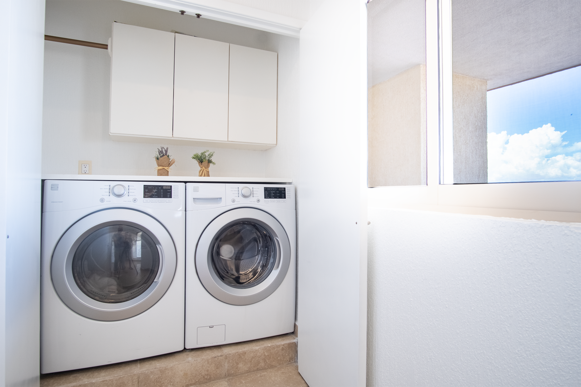 Washer and dryer in convenient nook by the entryway.