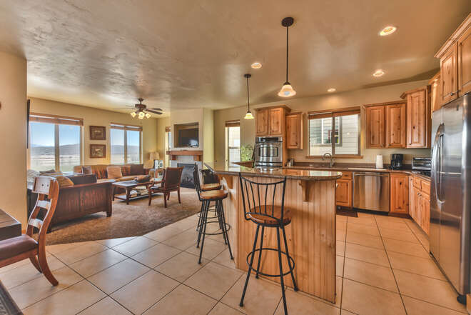 Fully Equipped Kitchen with Stainless Steel Appliances and Island Seating