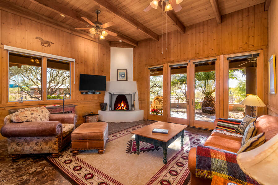 Experience the epitome of comfort and class in the cabin's living area, graced by a fireplace and a charming patio. Where relaxation meets sophistication.   #ElegantEscape