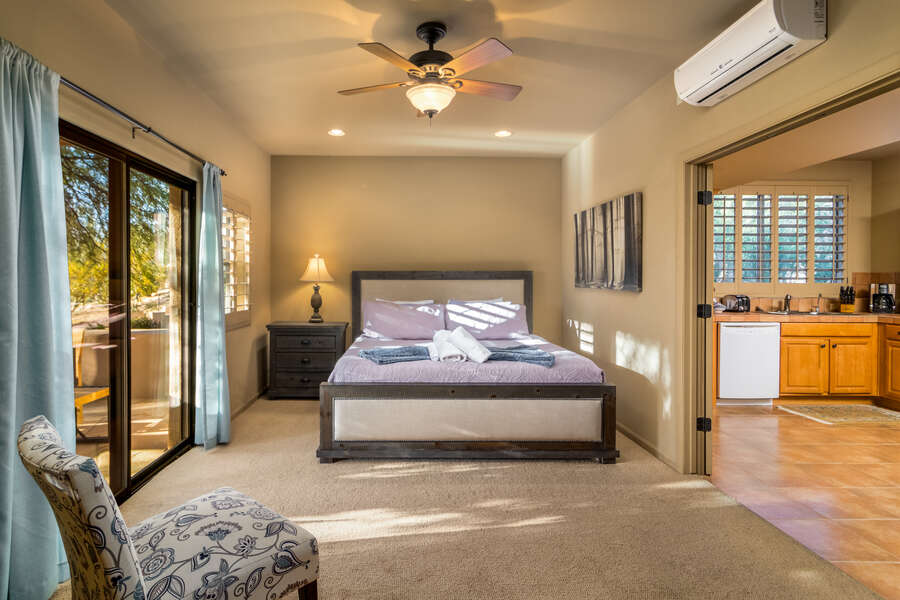 Experience comfort and elegance in a bedroom overlooking the kitchen through exquisite windowed French doors. #SeamlessElegance  ️ 