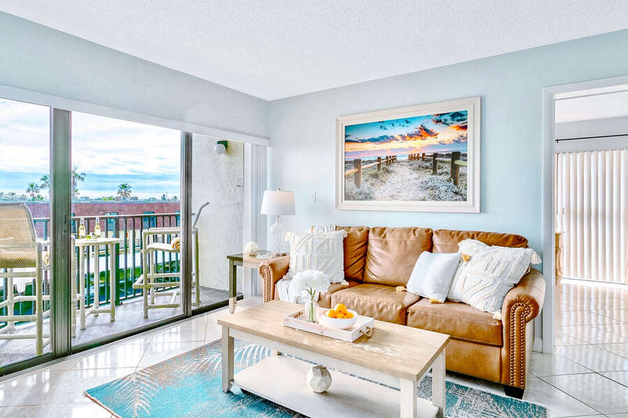Cozy living area with a soft couch natural light and a relaxing beach vibe