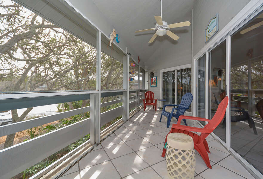 2nd floor, screened-in veranda of this Vacation Rental at New Smyrna Beach for relaxing or entertaining.