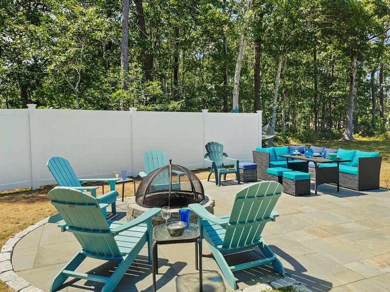 Large back yard to relax in with seating around the fire pit and dining table as well as a hammock to enjoy nearby - 33 Pine Grove West Harwich Cape Cod -  New England Vacation Rentals