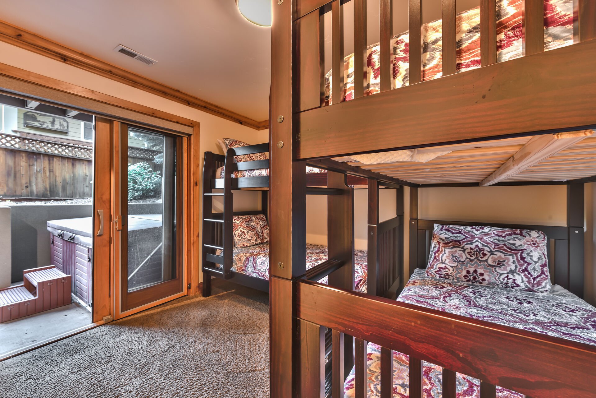 Level 1 Bedroom 3 with Two Twin over Twin Bunk Beds with a Private Bath and Patio Access with Hot Tub