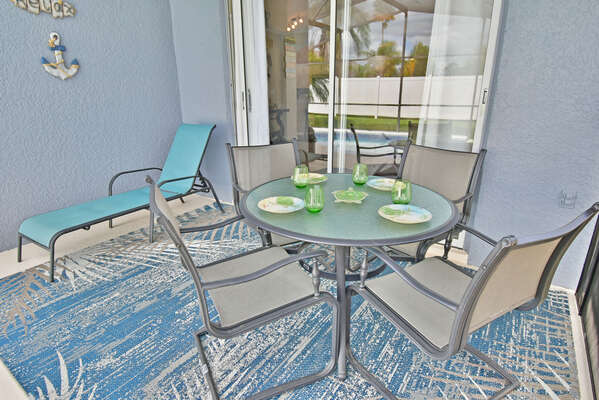 Shaded lanai area with glass patio table