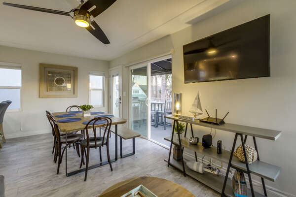 Sliding Doors, Dining Table, Chairs, Bookcase, TV, and Ceiling Fan.