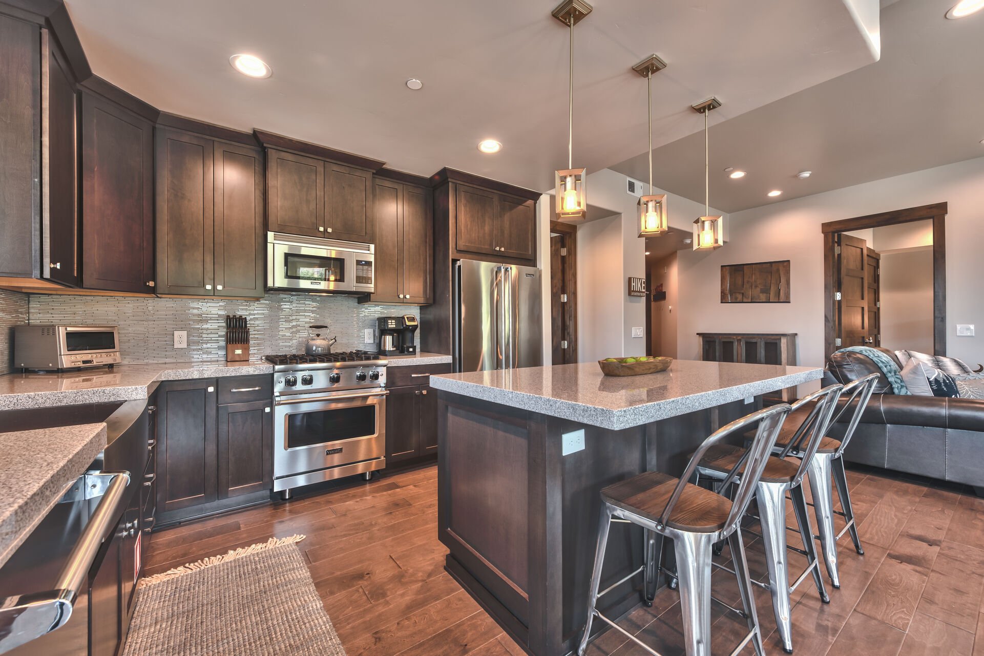 Fully Equipped Gourmet Kitchen with Quartz Counters, Viking Stainless Steel Appliances, including a Gas Range, and Kitchen Island Seating for 3