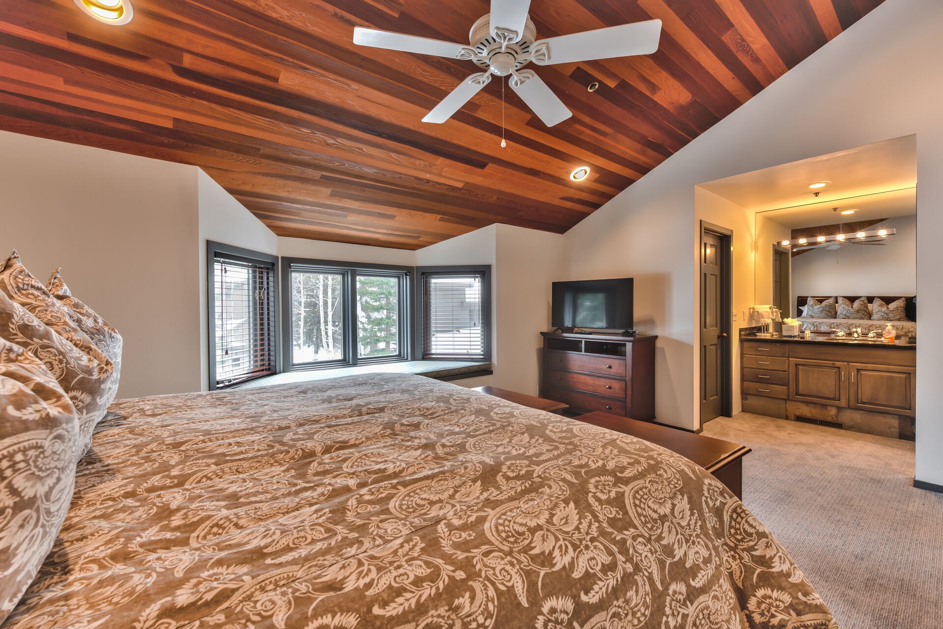 Upper Level Master Bedroom 2 has a King Bed, Window Bench Seating, TV, and Private Bath