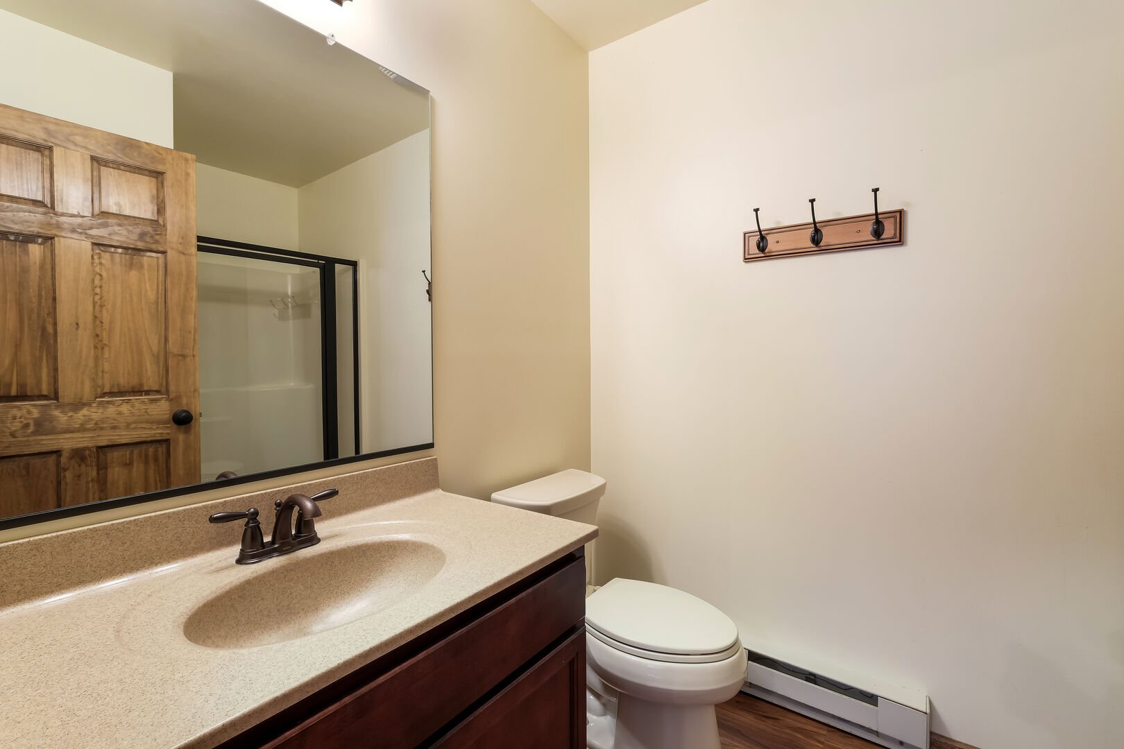 Toilet, sink, and mirror in a rental bathroom.
