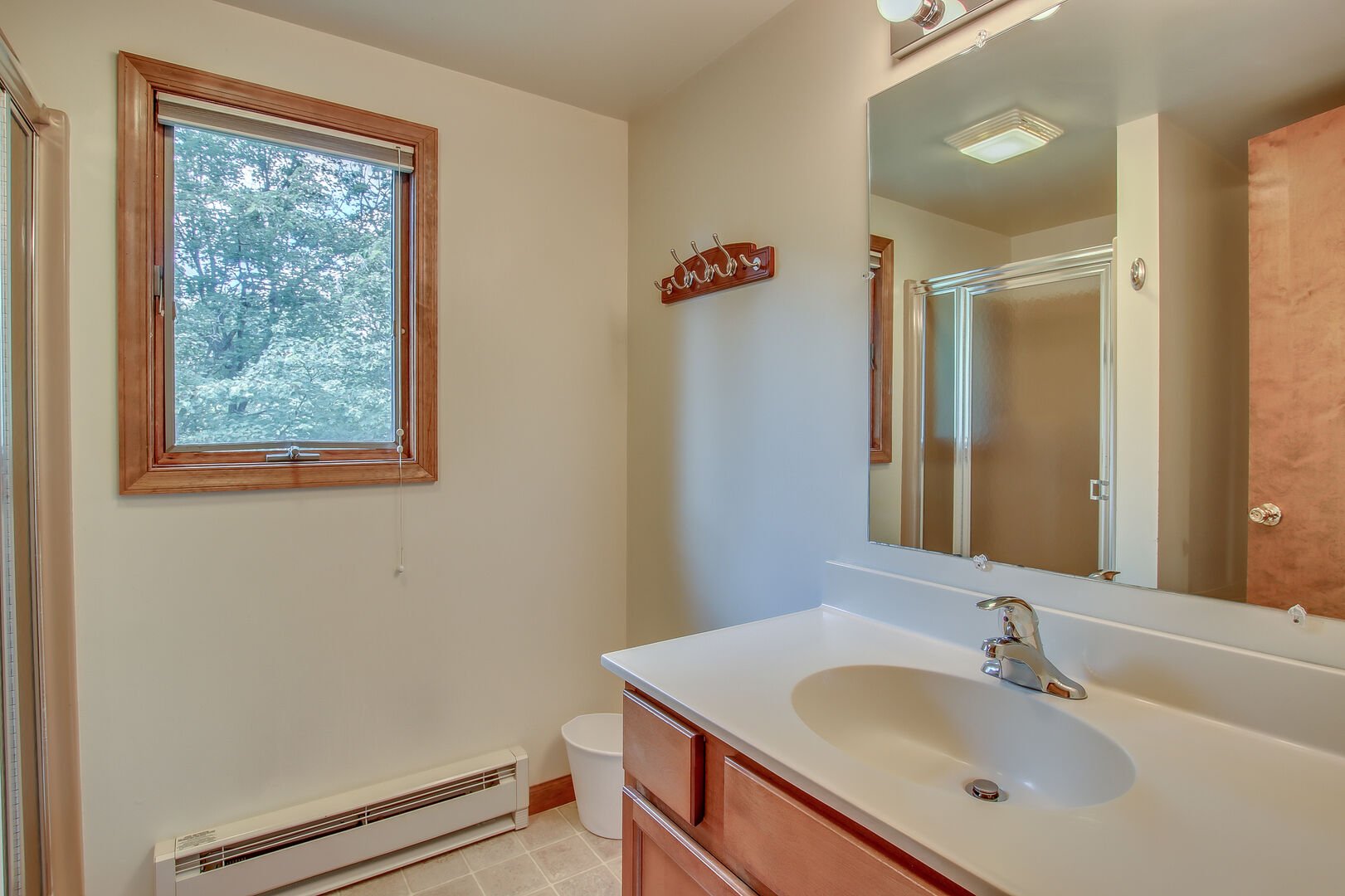 The sink and mirror in the bathroom of this Pocono rental in Towamensing Trails.