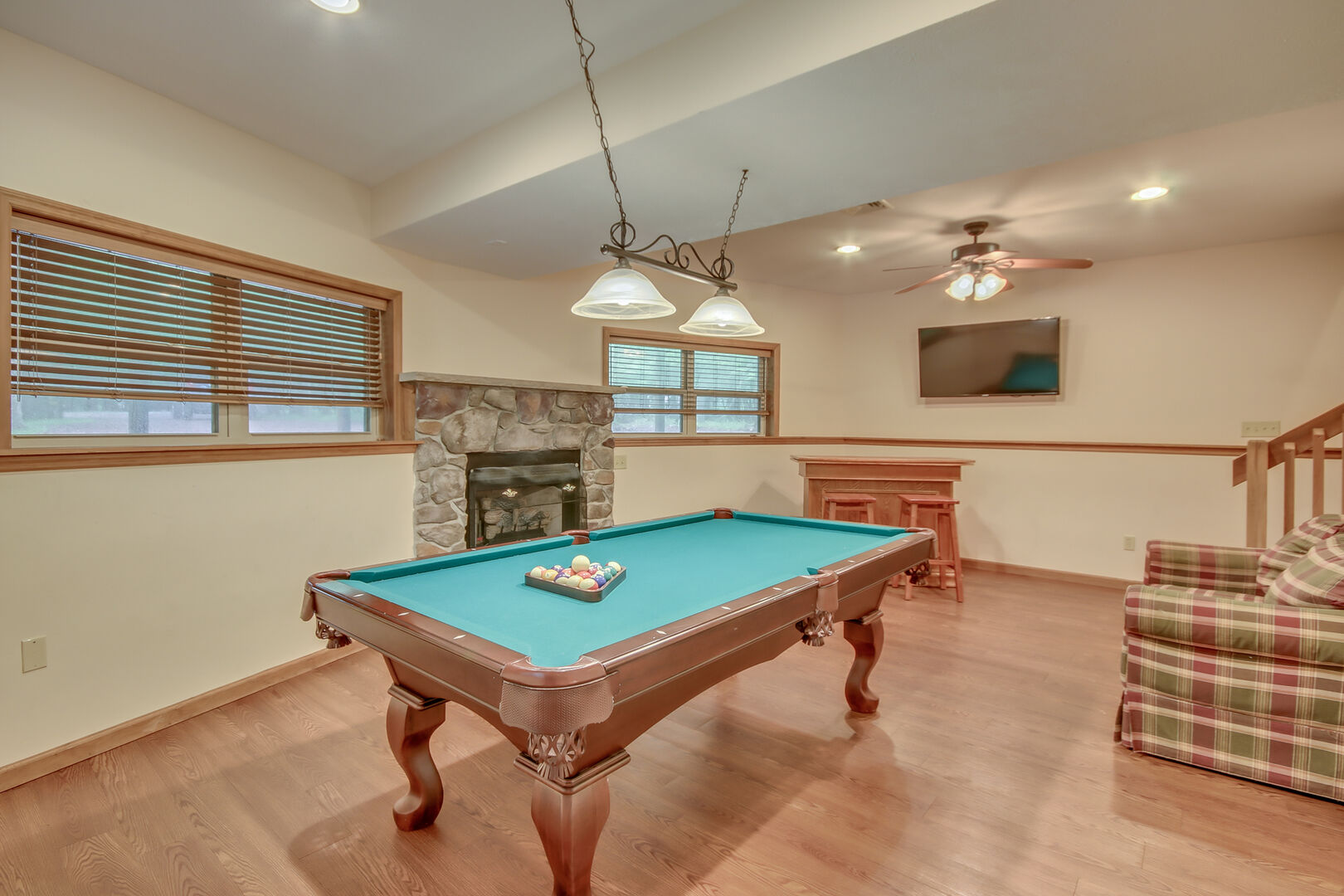 A Pool Table and Fireplace in the Game Room of Our Vacation Rental in the Poconos by Lake.