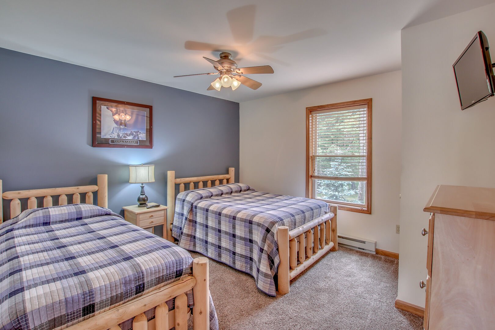blue bedroom with two beds and ceiling fan