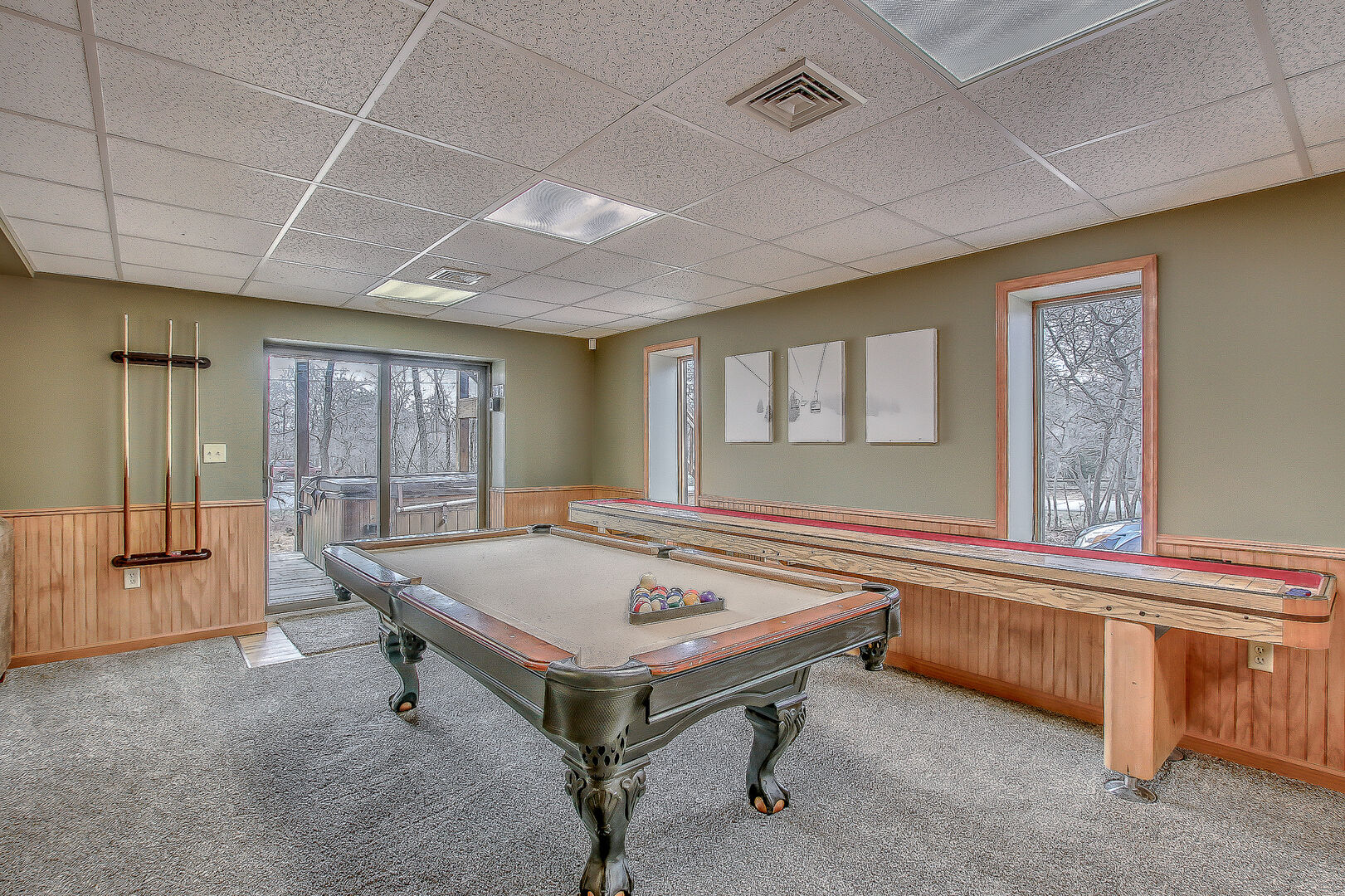 Spacious Game Room Features Pool Table and Shuffle Board.