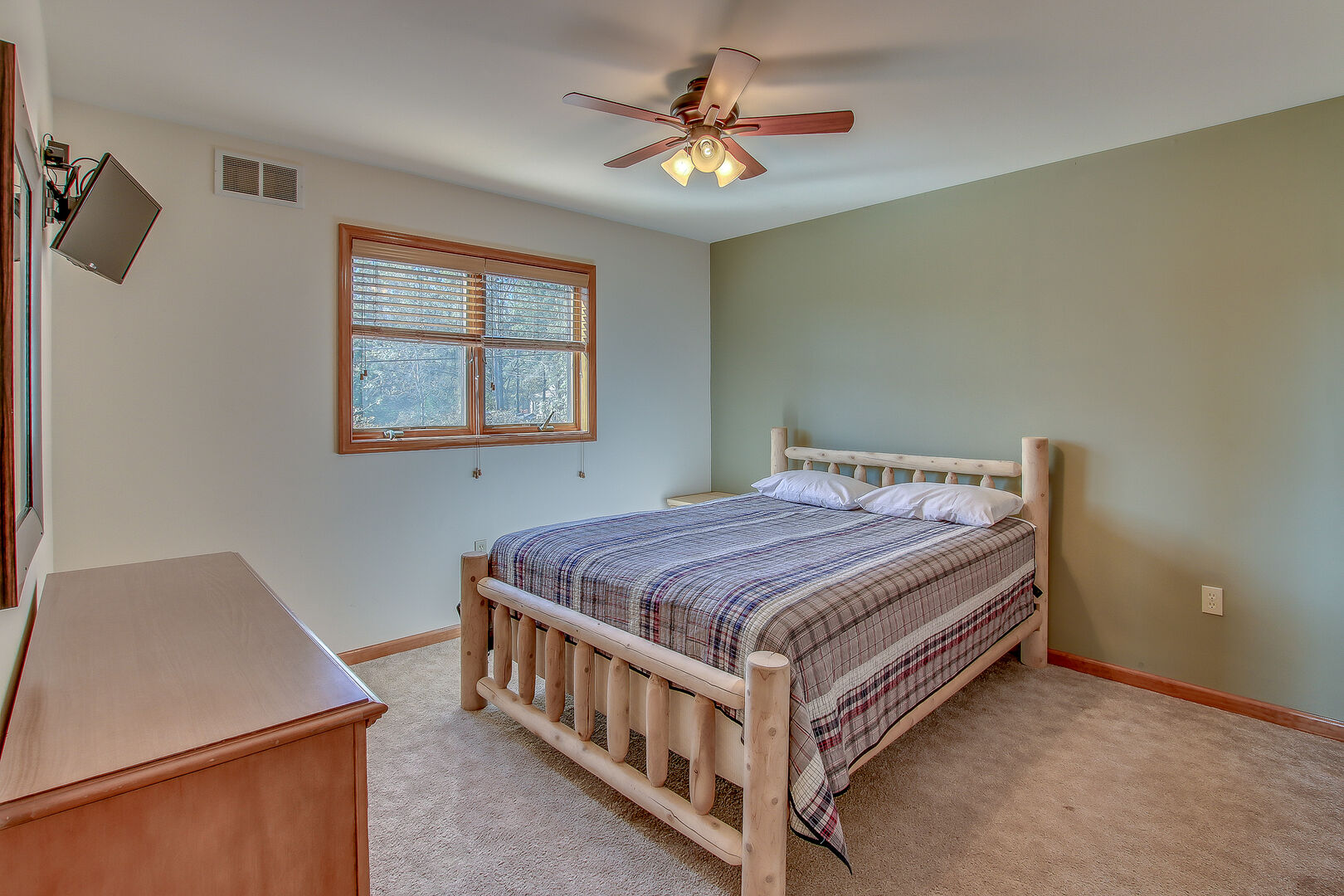 Bedroom in Poconos Lake Rental Featuring Wooden Bed.