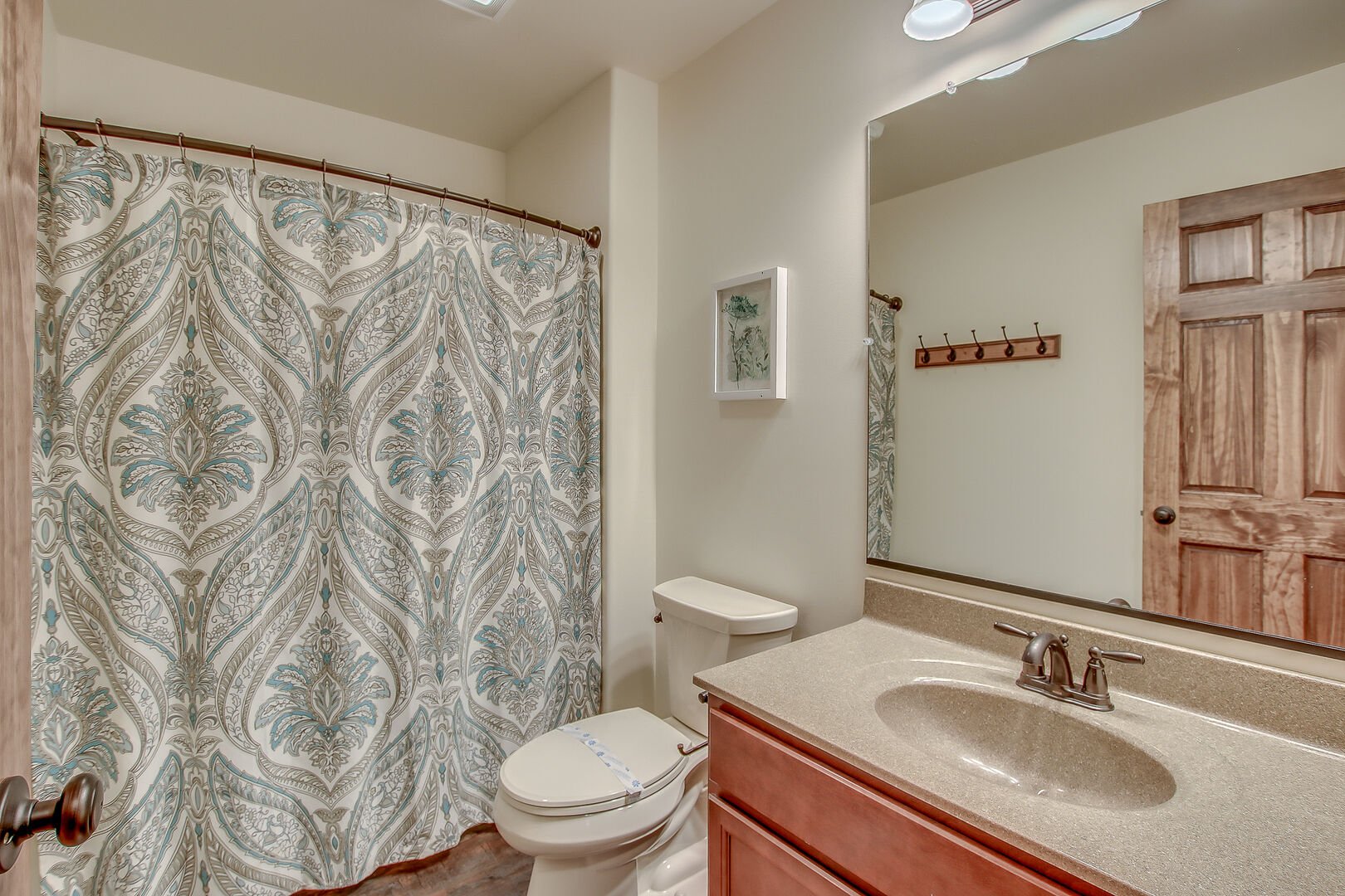 Bathroom with Sink, Toilet and Shower with Curtain