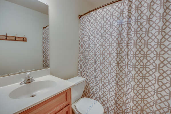 Bathroom Located in Vacation Rental in the Poconos by Lake with a Toilet and Shower.