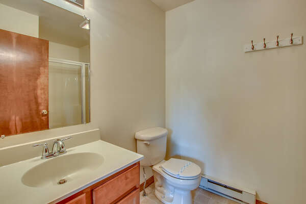 white bathroom with toilet and nearby sink