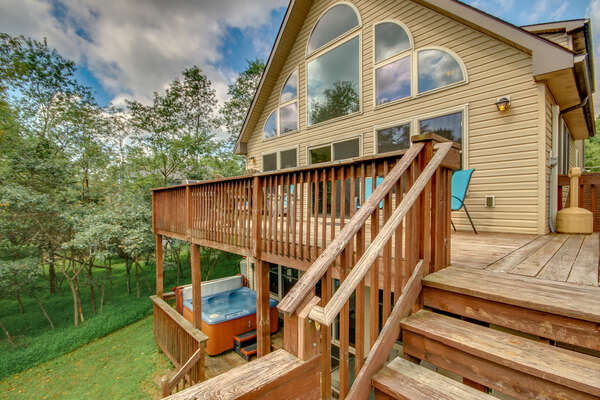 Lateral View of the Upstairs and Downstairs Deck, Patio Chairs, and Hot Tub.