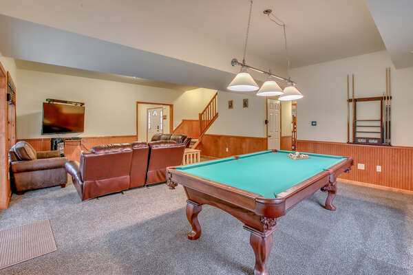 Game Room with Pool Table, Couches, and TV.