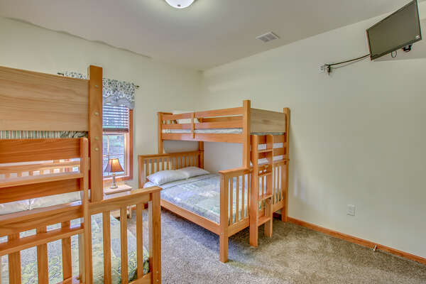 Bedroom with Two Bunk-Beds, Nightstand, and TV.