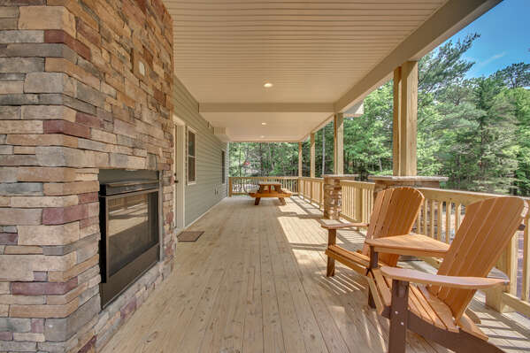 Wraparound Porch with Chairs and Fireplace outside 
