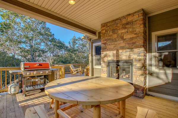 Grill, Table, and Fireplace on the Deck of our Poconos Luxury Rental