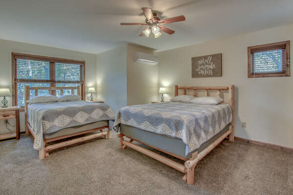 Spacious Bedroom with Two Beds and Ceiling Fan