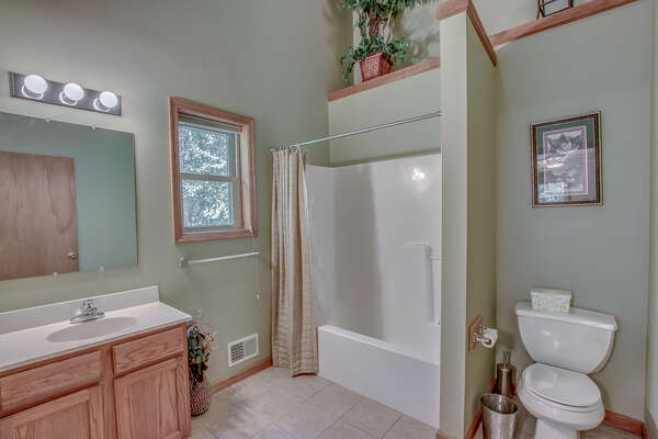This Lake Harmony rentals master bathroom, with shower, toilet, and double sink.