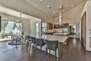 Kitchen Island with a Mini Fridge, Bar Seating, and a Breakfast Table with Floor to Ceiling Views of the Ski Runs