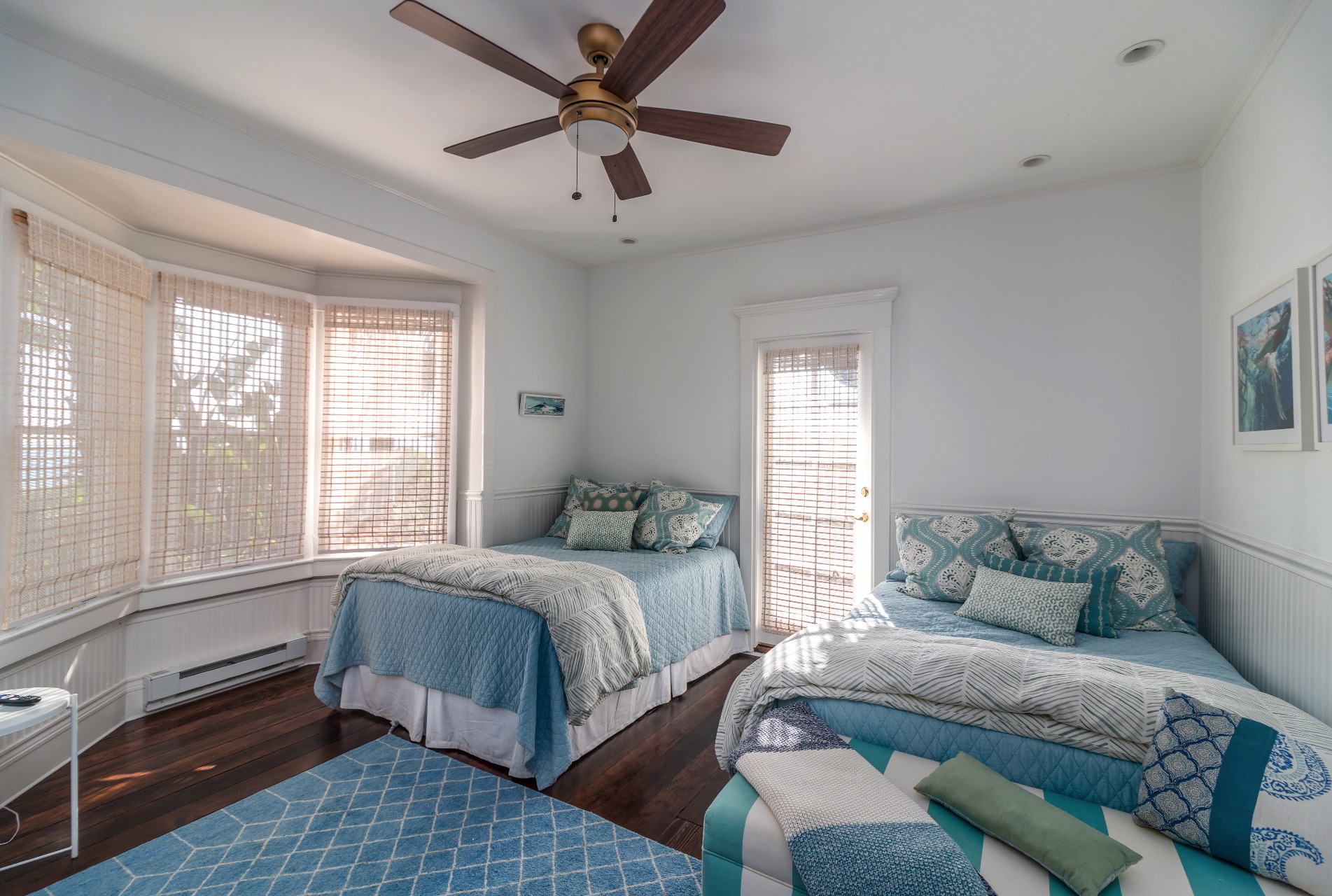 Two full beds, ceiling fan and door out to the side patio.