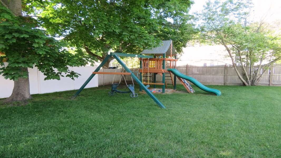 The swing set sits in the shade of the maple trees, perfect for the kids! - 25 Grey Neck Road West Harwich Cape Cod - New England Vacation Rentals