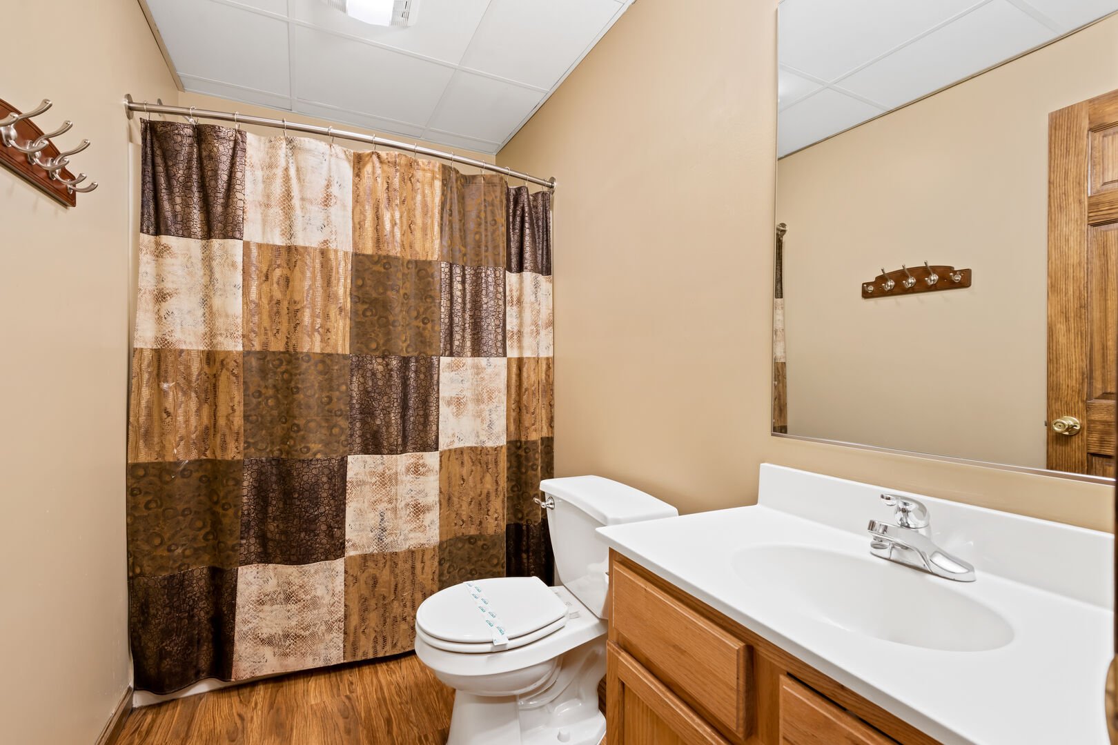 tan bedroom with shower and nearby sink