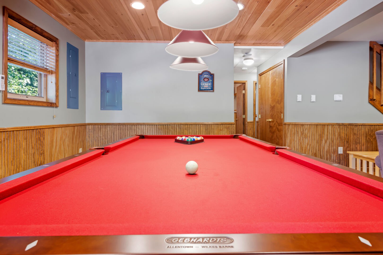 red velvet pool table in basement