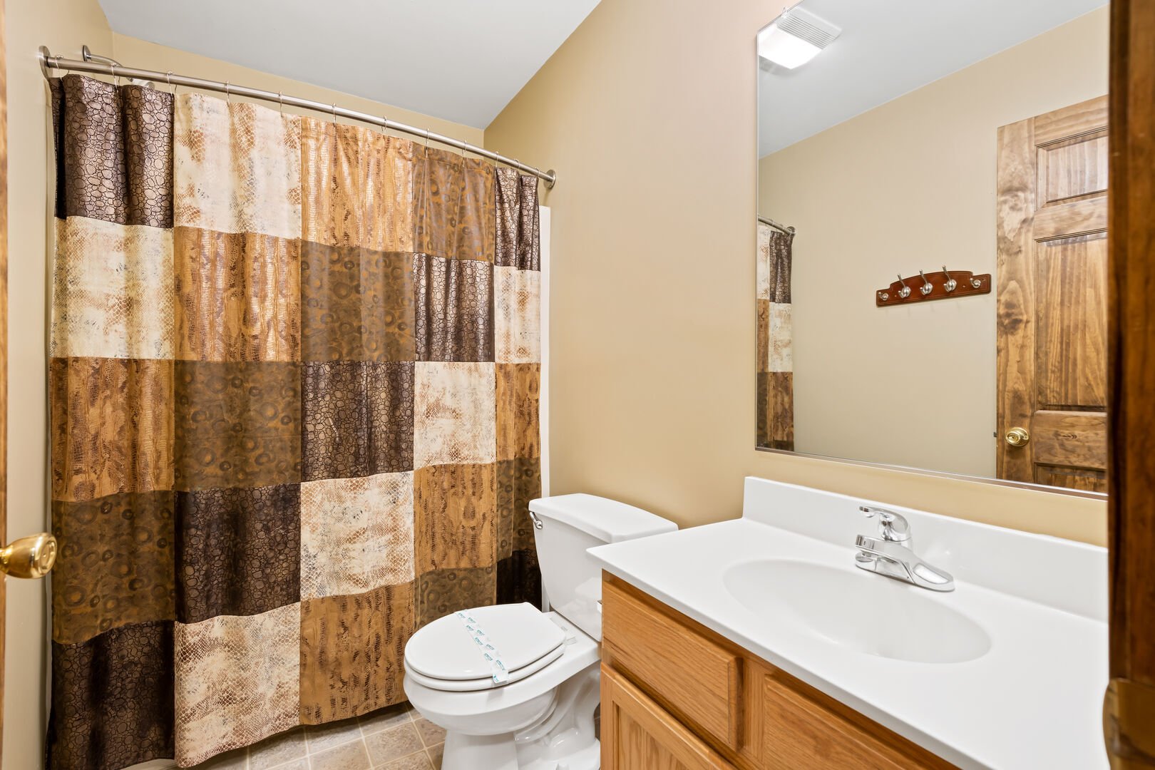 tan bathroom with shower and sink