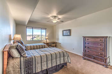 Fourth bedroom is downstairs on the ground level and includes 2 twin beds, a TV and tempting mountain views.