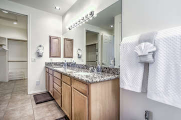 Spacious primary bath has dual sinks and a walk-in closet for your belongings.