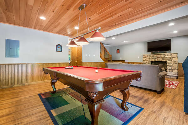 basement with pool table and couch