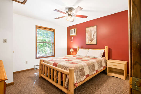 red bedroom with single bed and ceiling fan