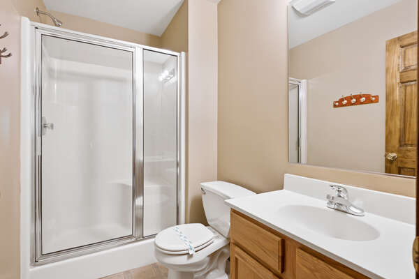 tan bedroom with walk-on shower and sink