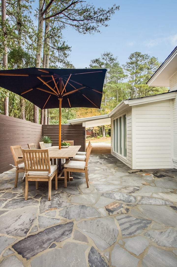 Backyard with Outdoor Dining Table with Umbrella and Chairs.