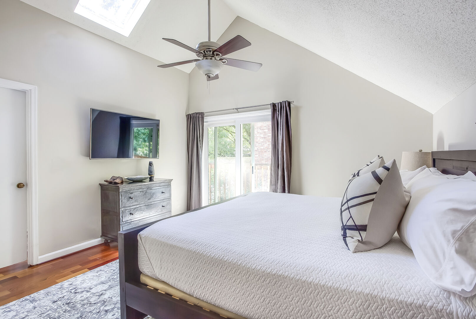This Poncey Highlands Rental has a master bedroom with TV and sliding class door