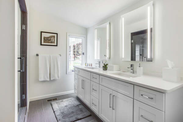 Double Vanity Sink, Mirrors, and Walk-In Shower.