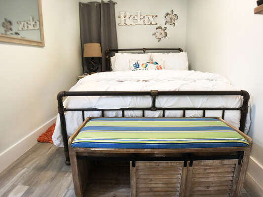 A super cute bench at the end of the bed to use for a little extra storage and a place to sit and put on your shoes!