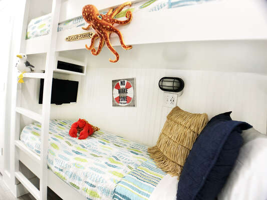The bunks were widened during the remodel to as wide as fire code would allow (narrower than a standard twin).  The bottom bunk has a TV with a Blu-ray player that the kids rave about!!