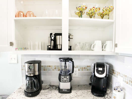 The Dry Bar holds the Keurig (we provide a few K-cups to get you started!), the drip coffee maker and the Ninja Blender!!!  It also holds all of the glasses you need for any type of drink you want!